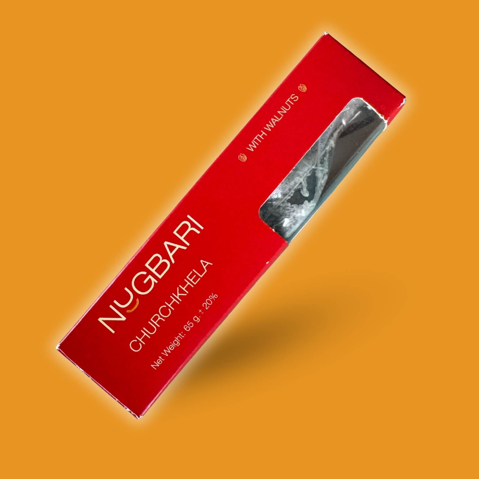 Small red box of Nugbari Churchkhela with walnuts, a traditional Georgian sweet made from grape juice and walnuts, healthy no-sugar snack.
