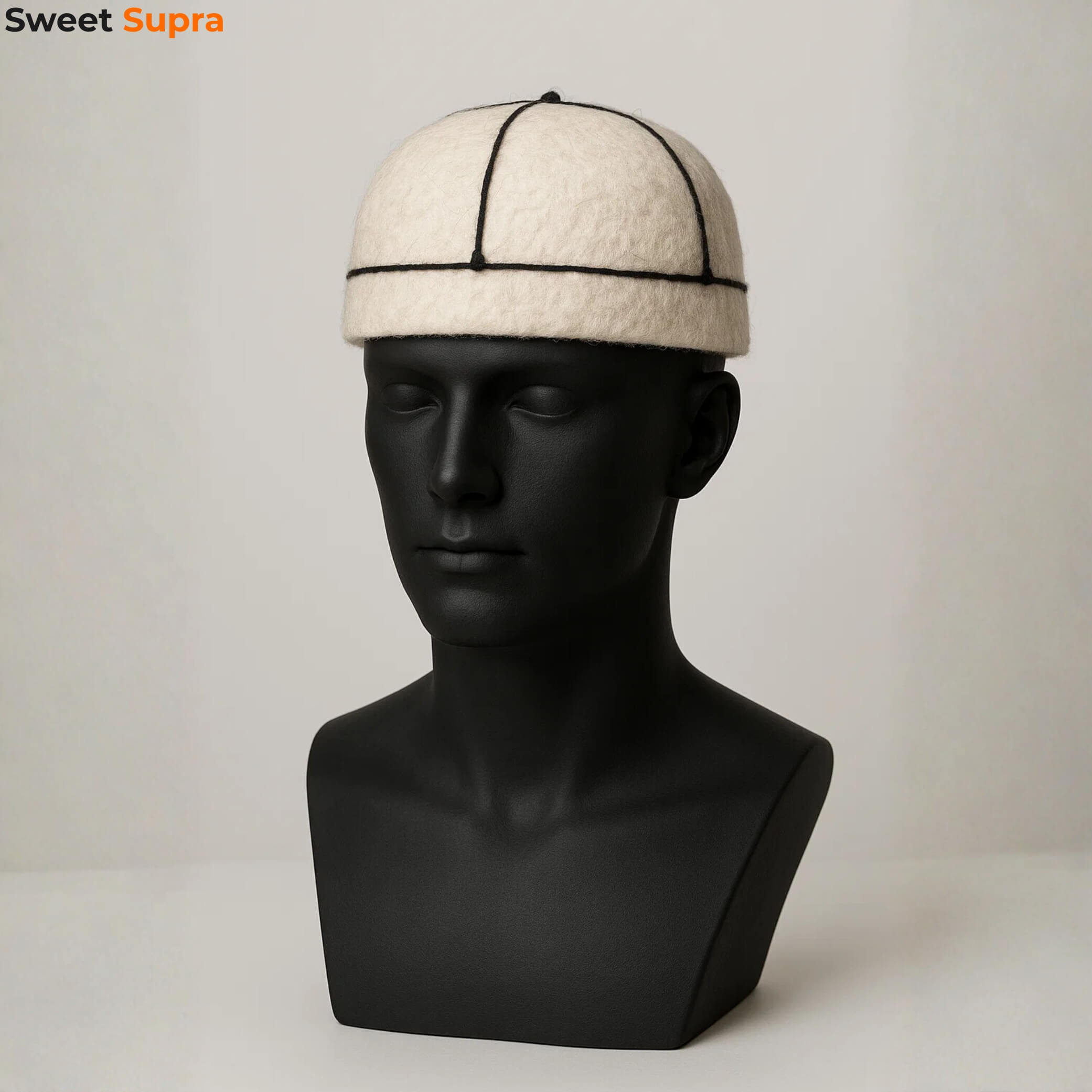 White Georgian Svan hat displayed on a black mannequin. Classic highland Georgian design made of white felt with seam detailing.